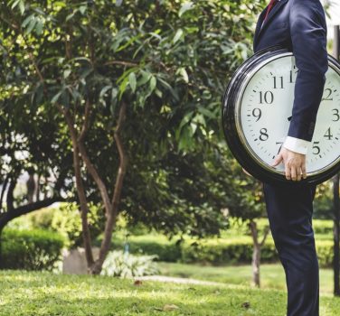 image of man holding clock